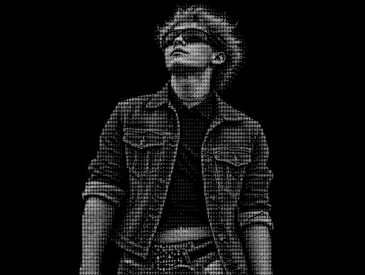 Grayscale ASCII portrait of a person wearing a denim jacket, looking upward.