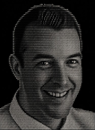Grayscale ASCII-style portrait of a smiling person against a dark background