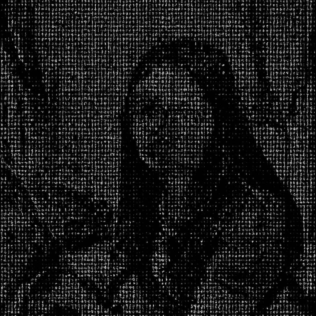 a woman wearing glasses sitting on a bed