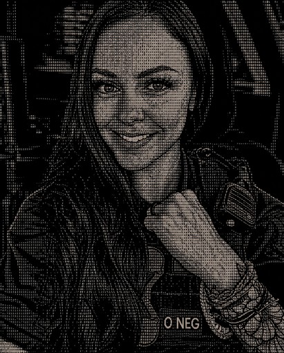 Black-and-white ASCII portrait of a smiling person wearing a jacket and necklace.
