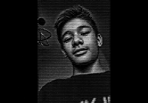 Grayscale halftone portrait of a person looking at the camera.